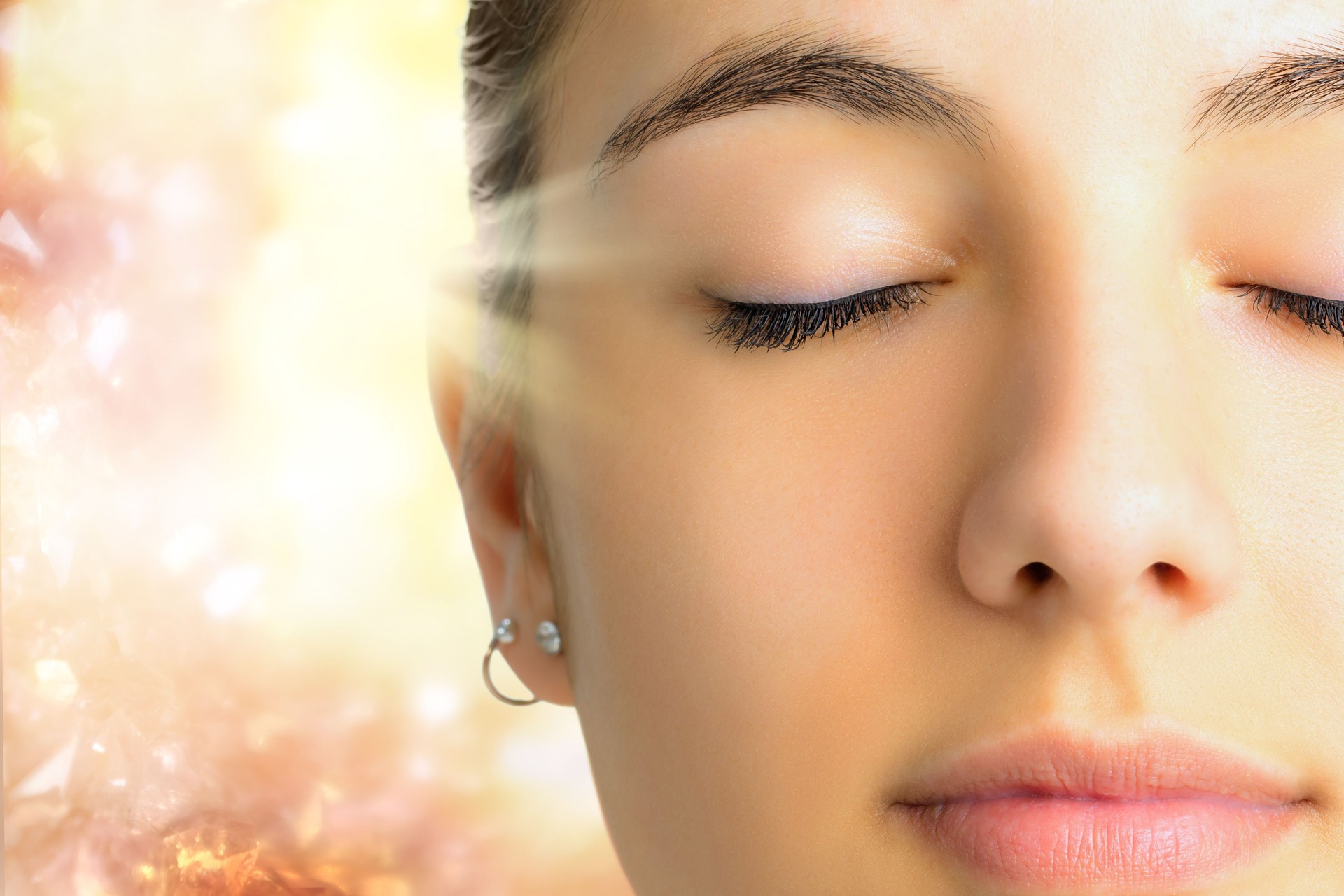 Relaxed face shot of woman meditating.